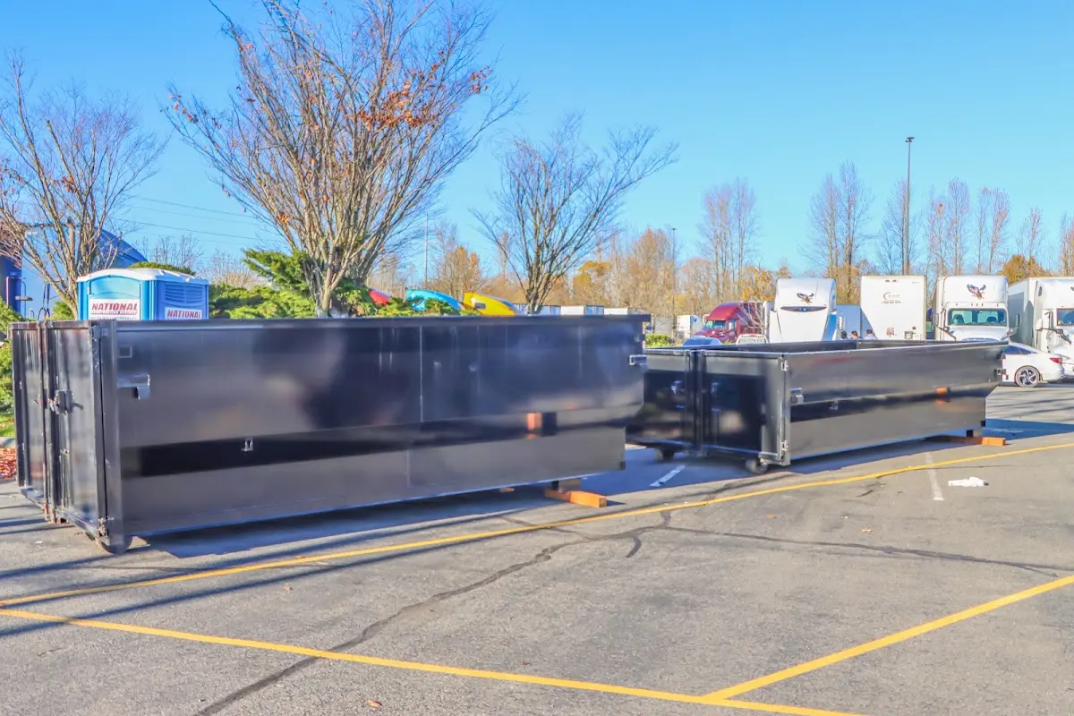 Professional dumpster rental service with roll-off container on residential driveway in West Hempfield